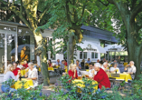 An warmen Tagen wird im Biergarten zur Geselligkeit aufgerufen.